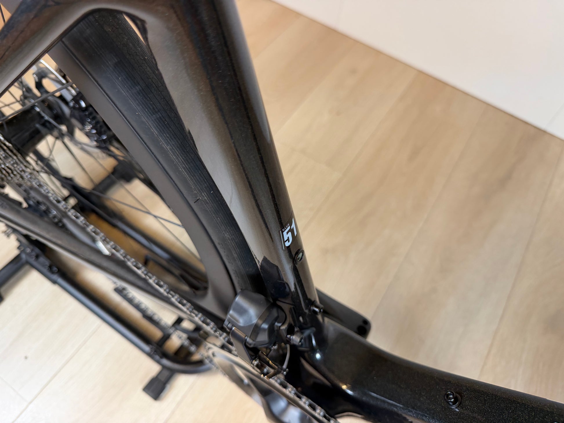 Cervélo Soloist racefiets met zwart frame en aerodynamisch ontwerp, gefotografeerd van bovenaf op houten vloer, door Vélo Studio.