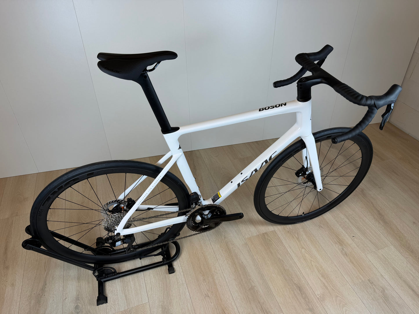 Witte Isaac Boson Mineral White 2026 XL racefiets van Vélo Studio, close-up van het frame en wiel.