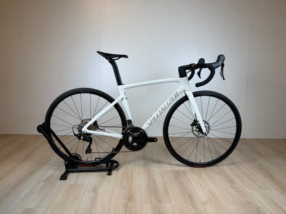 Racefiets Specialized Tarmac SL7 Sport in zwart en rood, close-up van het frame en wiel, geschikt voor snelle wielerritten.