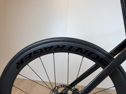 Fietsfoto van een Trek Madone SL 6 racefiets met lichtgewicht frame en aerodynamisch ontwerp, geplaatst op een weg.