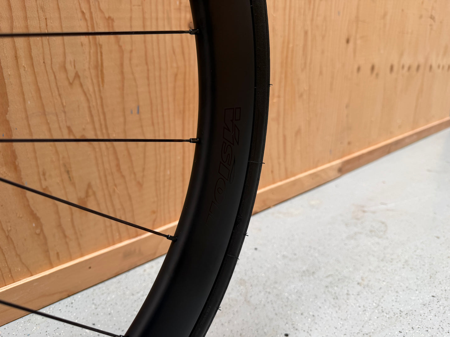 Zwart Colnago V4 racefiets met Shimano 105 Di2 elektrische groepset en aerodynamisch frame, zichtbaar op de afbeelding.