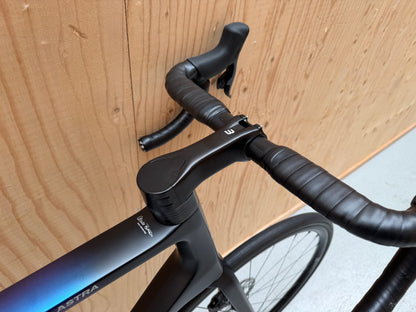 Basso Astra fiets van Velostudio, zwart met blauw frame en ergonomisch ontworpen stuur, klaar voor gebruik